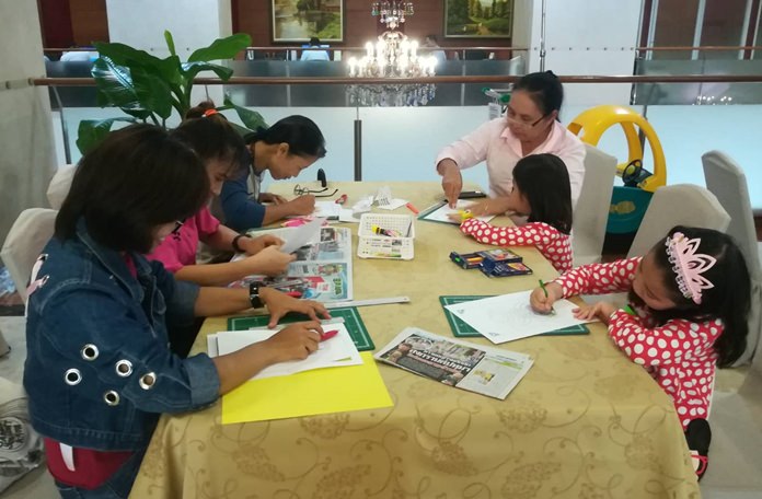Mothers and their children enjoy making greeting cards at the workshop.