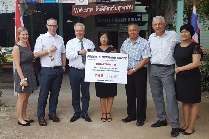 Consul General Gerhard Götz and his wife Frosie (centre) together with their entourage present a cheque to Palisorn Noja director of the ATCC. 