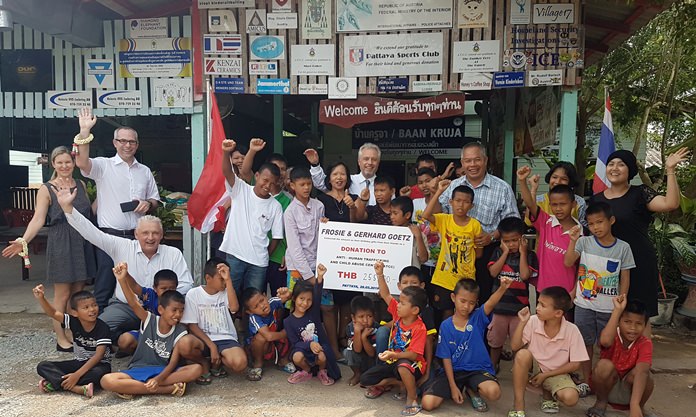 The benefactors pose for a photo with the happy children.