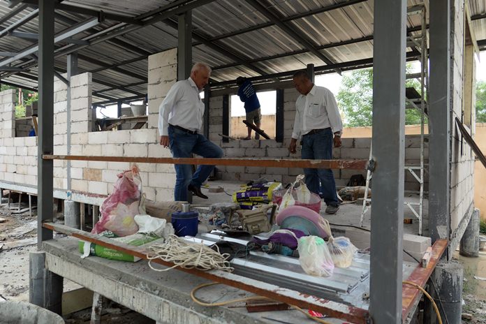 The police liaison attaché visits the new building under construction. 