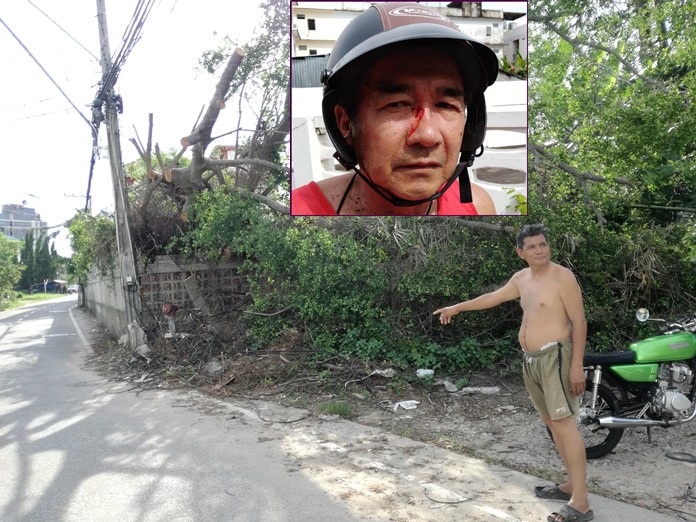 A resident points to the spot where a hapless motorcyclist (inset) got entangled in the sagging wires resulting in facial injuries.
