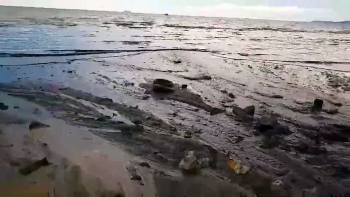 The ugly mass of raw sewage covers the beach.