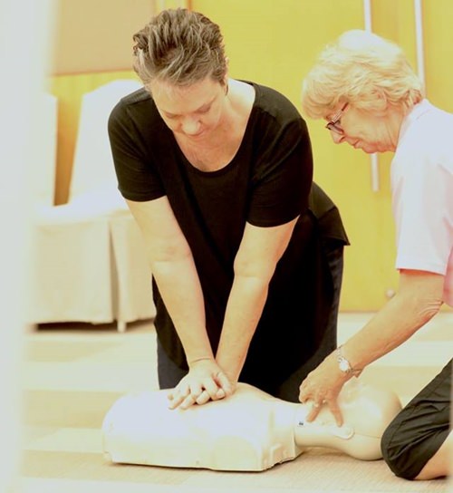 Volunteers from Hand to Hand Foundation are shown how to position a head before giving mouth to mouth resuscitation.