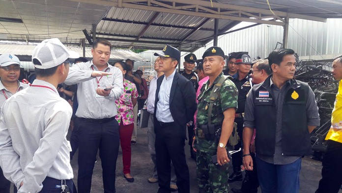 District Chief Naris Niramaiwong leads a team to inspect the offending paint factory. 