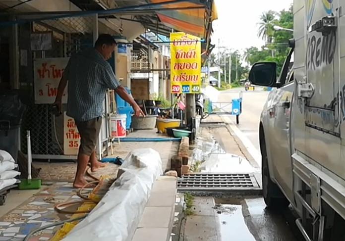 Sondej Boontuam points at the engineering marvel of the contractors that caused the drains to be stuffed with sand and garbage.