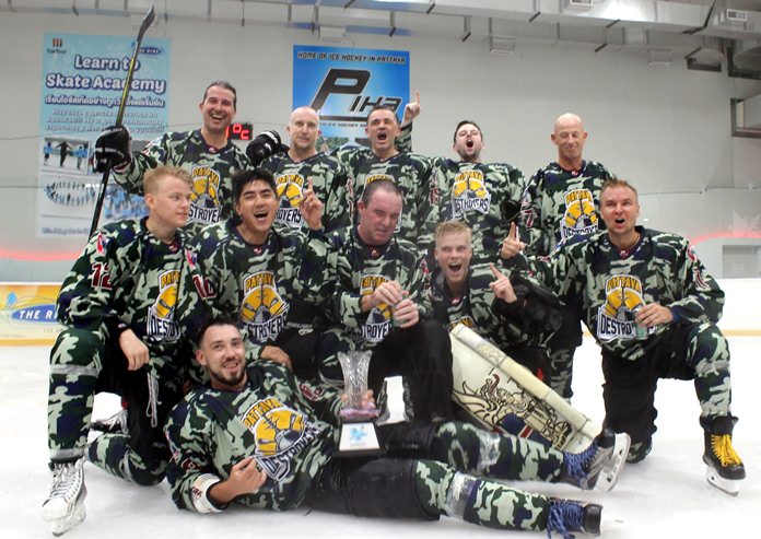 Pattaya Destroyers team members celebrate with the trophy after winning the Gulf of Siam Ice Hockey Classic at Harbor Mall in Pattaya, Saturday, May 19.