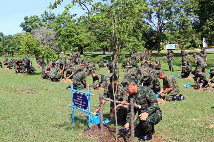 Capt. Sarawuth Chawana (foreground) leads his troops in planting 40 Yellow Star trees, the official tree of His Majesty King Rama X, on National Tree Day.
