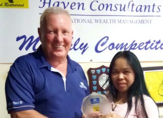 Poopay (right) receives her medal from Brian Chapman.