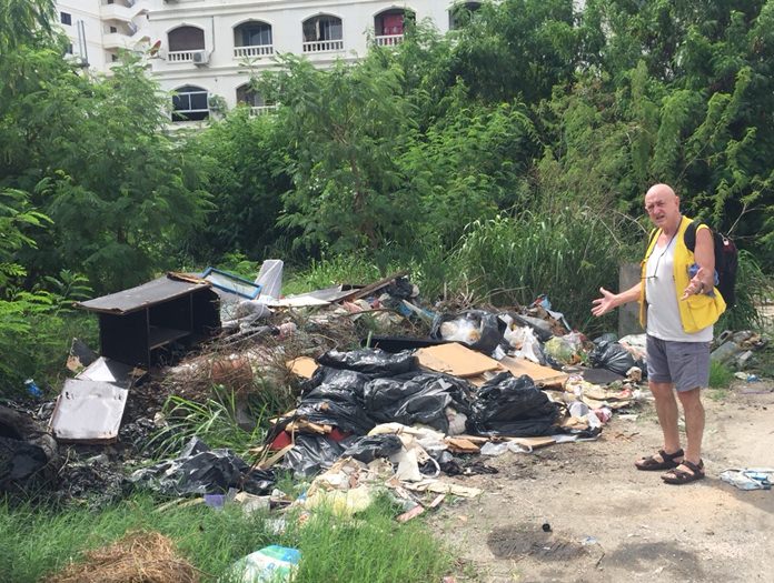 An expat resident in central Pattaya, who didn’t provide his name, shows a reporter a large pile of waste on Soi Arunothai that has been ignored by the city for weeks.