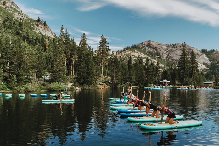 Participants work out on paddle boards during Wanderlust Squaw Valley 2017, in North Lake Tahoe, Calif. (Amanda Senior/Wanderlust via AP)
