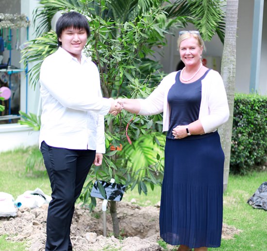 Mangpo shakes hands with GIS Principal Mrs Hawtree after his tree-planting.