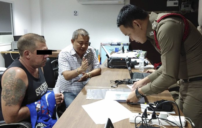 Australian Stephen Allan Carpenter, left, is detained by police in Pattaya, Thailand. Carpenter was arrested on vice charges in a sting operation after allegedly offering a sex cruise with prostitutes via a Facebook page. (AP Photo)