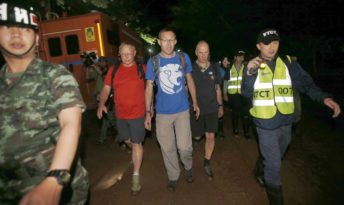The British Cave Rescue Council members from second left, Robert Charles Harper, John Volanthen and Richard William arrive at cave in the staging area as they continue the search for a young soccer team and their coach believed to be missing in a large cave, Wednesday, June 27, 2018, in Mae Sai, Chiang Rai province, in northern Thailand. (AP Photo/Sakchai Lalit)