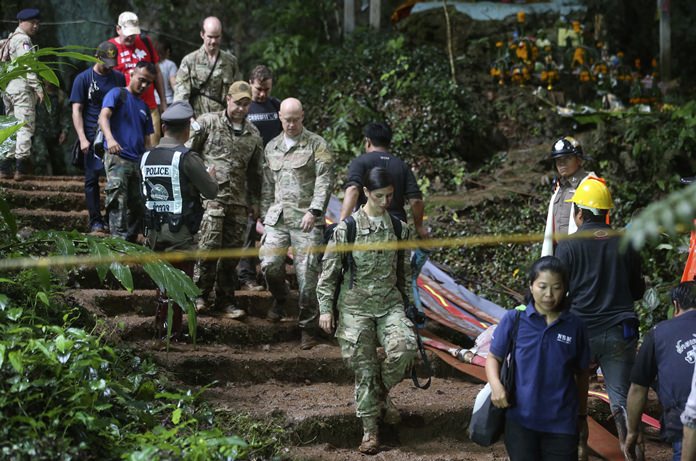 U.S. Special Operations Command Pacific Search and Rescue team personnel walk out of the cave where a young soccer team and their coach are believed to be missing, Thursday, June 28. (AP Photo/Sakchai Lalit)