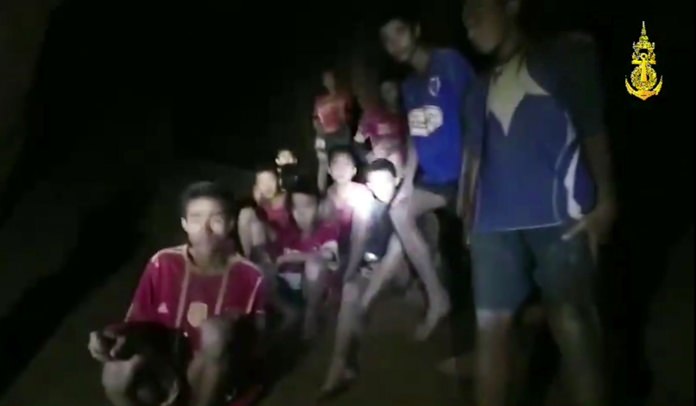In this grab taken from video provided by the Thai Navy Seals, the 12 boys and their soccer coach are found in the flooded cave, Monday, July 2, some 10 days after they disappeared and touched off a desperate search that drew international help and captivated the nation. (Thai Navy Seal via AP)