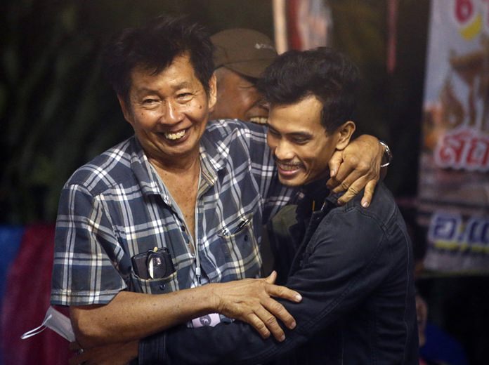Family members smile after hearing the news that the missing boys and their soccer coach have been found, in Mae Sai, Chiang Rai province, Monday, July 2. (AP Photo/Sakchai Lalit)