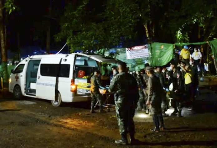 In this grab taken from video provide by Chiang Rai Public Relations Office, emergency workers carry a stretcher with one of the rescued boy to be transported by ambulance to a hospital, in Mae Sai, Sunday, July 8. (Chiang Rai Public Relations Office via AP)