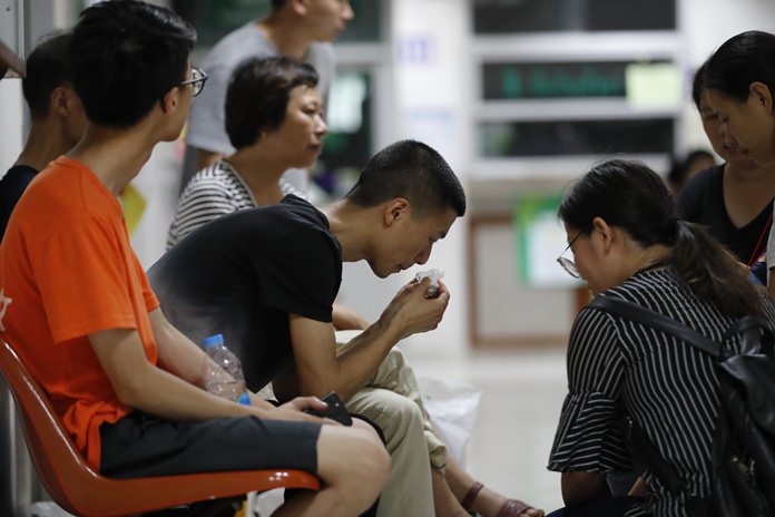 A Chinese relative of a victim in the recent boat sinking is consoled at the Vachira Phuket Hospital in Phuket, Sunday, July 8. (AP Photo/Vincent Thian)