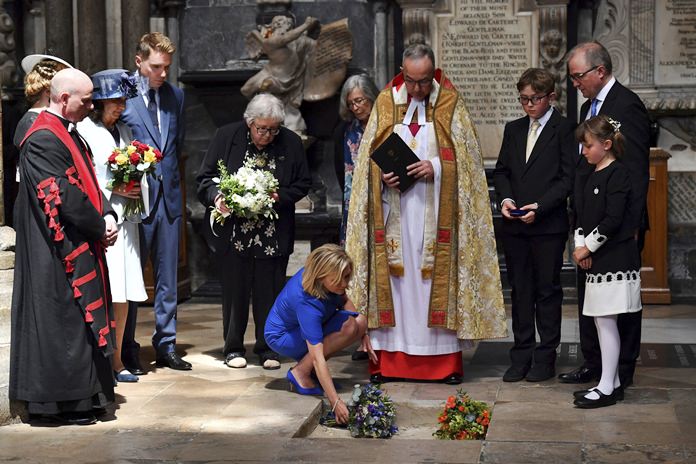 Lucy Hawking lays flowers as the ashes of her father, Professor Stephen Hawking, are laid to rest during his memorial service at Westminster Abbey in London, Friday June 15, 2018. Hawking has taken his place among Britain’s greatest scientists with his ashes buried in Westminster Abbey, between the graves of Charles Darwin and Isaac Newton. (Ben Stansall/PA via AP)
