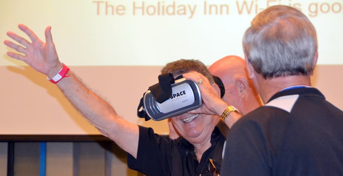 Jakob Friis before his presentation invited PCEC members and guests to try on some of the Virtual Reality goggles he brought with him to experience its wonders. Here, member Jim Johnson is thoroughly enjoying the experience.