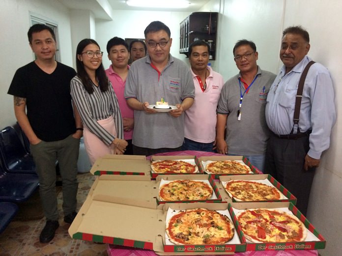 Longtime Pattaya Mail employee Manus Boonyakovit (center) celebrated both his birthday and a return to journalism with a party at the newspaper’s office.