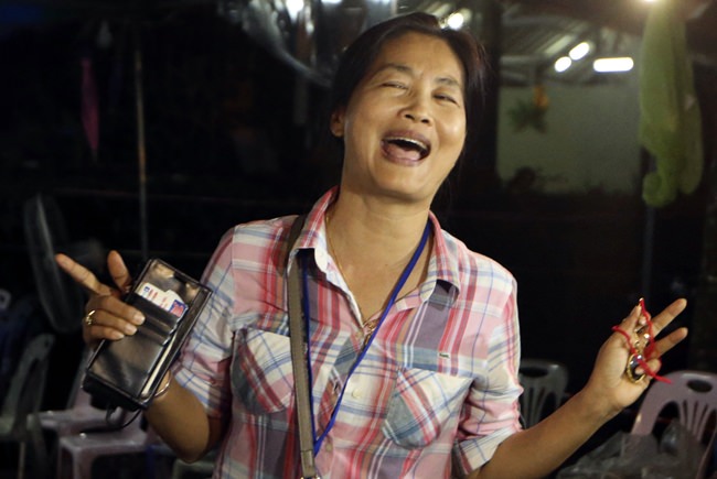 A family member smiles after hearing the news that the missing 12 boys and their soccer coach have been found. (AP Photo/Sakchai Lalit)