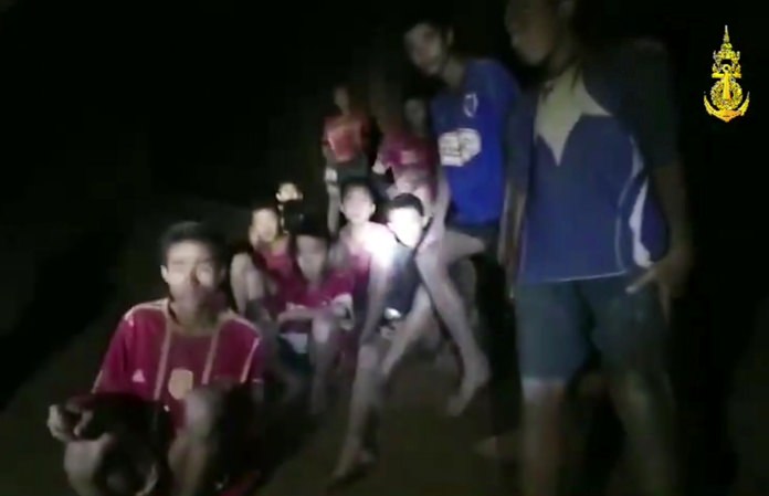 This grab taken from video provided by the Thai Navy Seals shows the 12 boys and soccer coach as they are rescued on Monday, July 2. They were found mostly in stable medical condition after being lost for 10 days in a partially flooded cave in Chiang Rai, northern Thailand. They have received high-protein liquid food, officials said Tuesday, though, at the time of Pattaya Mail going to press, it was not known when they would be able to go home. (Photo: Thai Navy Seal via AP) 