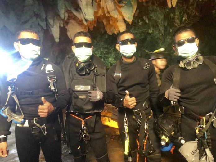 The last four Thai Navy SEALs give their thumbs up as they emerge safely after completing the rescued mission inside a cave where 12 boys and their soccer coach had been trapped since June 23, in Mae Sai, Chiang Rai, northern Thailand. Thailand’s navy SEALs say all 12 boys and their soccer coach have been rescued, ending an ordeal that gripped the world as it lasted more than two weeks. (Royal Thai Navy via AP)