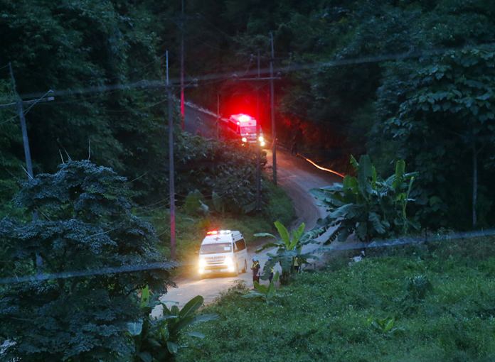 Two ambulances with flashing lights leave the cave rescue area. (AP Photo/Sakchai Lalit)