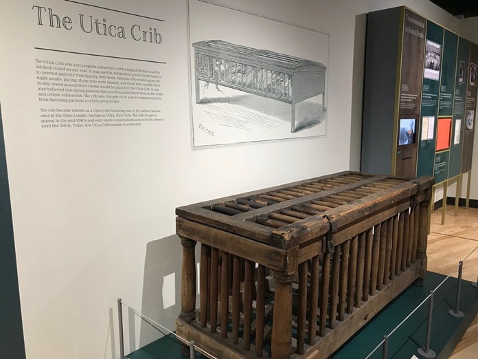 In this June, 29, 2018, photo, a cage for humans known as the Utica Crib is displayed at the National Museum of Psychology in Akron, Ohio. It was used in early asylums to restrain mental patients in their beds. (AP Photo/Mitch Stacy)