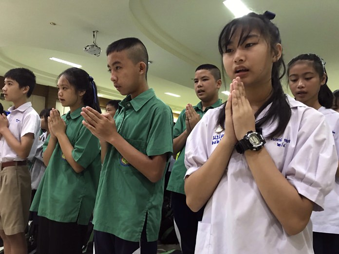 Students pray at Maesaiprasitsart School where six out of the rescued 12 boys study as they cheer the successful rescue July 11. (AP Photo/Johnson Lai)