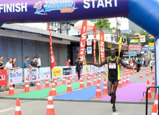Bernard Kiplangat Kibilo of Kenya crosses the finish line to win the men’s marathon, Sunday July 15.