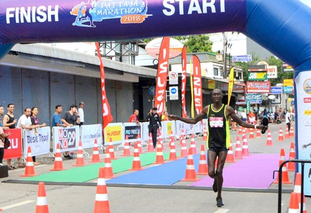 Bernard Kiplangat Kibilo of Kenya crosses the finish line to win the men’s marathon, Sunday July 15.