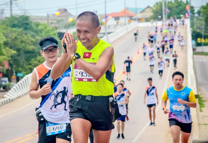 A runner thanks spectators for their support on his way around the marathon course.