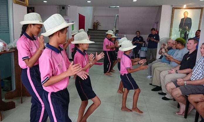Children perform a talent show for the visitors.