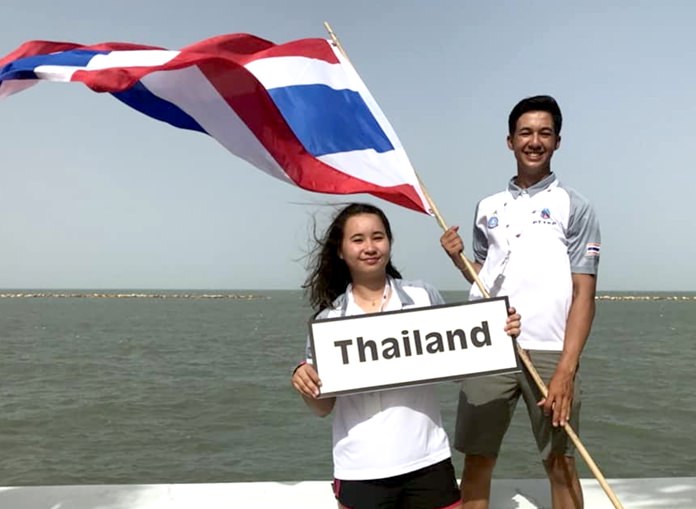 Arthit Romanyk (Miki) holds the Thai flag as he poses with his sister Janisara Romanyk (Sasha) at the 48th Youth Sailing World Championships in Corpus Christi, Texas.