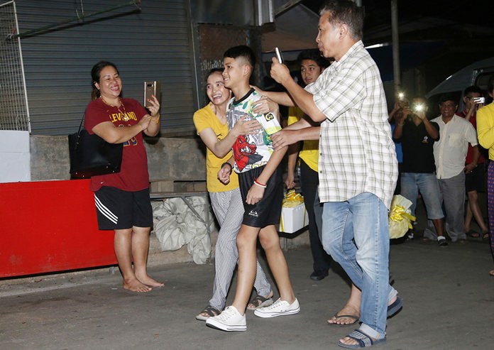 Relatives of Duangpetch Promthep greet him as he arrives home in Mae Sai district, Chiang Rai. (AP Photo/Sakchai Lalit)