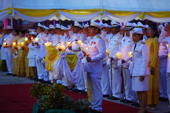 District Chief Naris Niramaiwong and Pattaya City Manager Chanatpong Sriviset lead city council members and the public in a candlelight ceremony at the district office.
