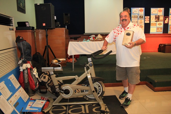 Jack Levy with his Royal Salute and exercise bike raffle prizes.
