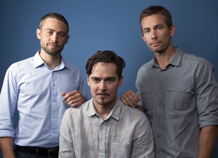 In this Wednesday, Aug. 8, 2018 photo, Cody Walker (left), Adrian Buitenhuis (center) and Caleb Walker pose for a portrait in Los Angeles, in promotion of the documentary film “I Am Paul Walker.” (Photo by Rebecca Cabage/Invision/AP)
