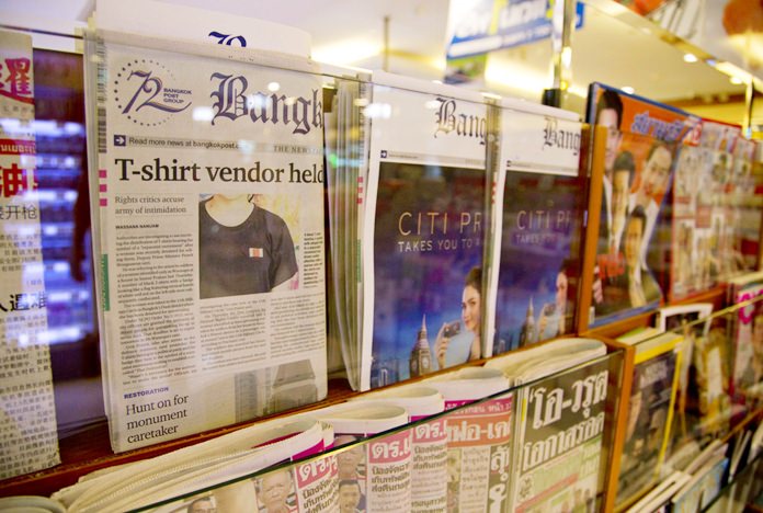 Thailand's Bangkok Post newspaper depicting a cover story on detention of a vender who sold black t-shirts, bearing a symbol allegedly linked to a movement promoting a federal republic, is displayed in a newspaper stall in Bangkok, Thailand, Tuesday, Sept. 11, 2018. (AP Photo/Gemunu Amarasinghe)