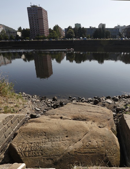 On of the so called “hunger stones” exposed by the low level of water in the Elbe River in Decin, Czech Republic, Thursday, Aug. 23, 2018. (AP Photo/Petr David Josek)