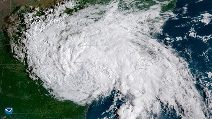 This satellite image provided by NOAA shows Tropical Depression Florence moving west across the United States on Sunday, Sept. 16. (NOAA via AP)