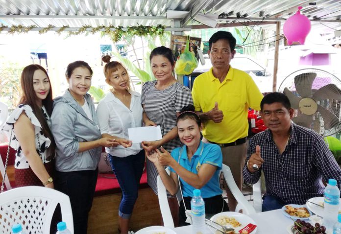 Pol. Sub-Lt. Dawan Pamee leads a squad of officers and local benefactors to treat kids at the Soi Khopai Child Development Center to lunch