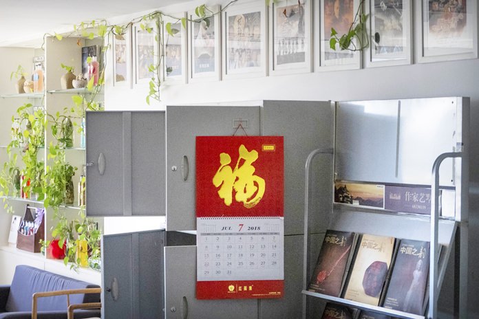 A calendar dated July 2018 hangs from a cabinet in the management office of actor Fan Bingbing in Beijing. (AP Photo/Mark Schiefelbein)
