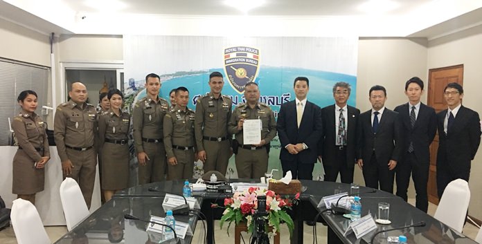 Japanese embassy officials thank the Chonburi Immigration Office for apprehending a gangster accused of stealing 30 million baht in luxury-brand goods from southern Japan homes over the past 20 years.