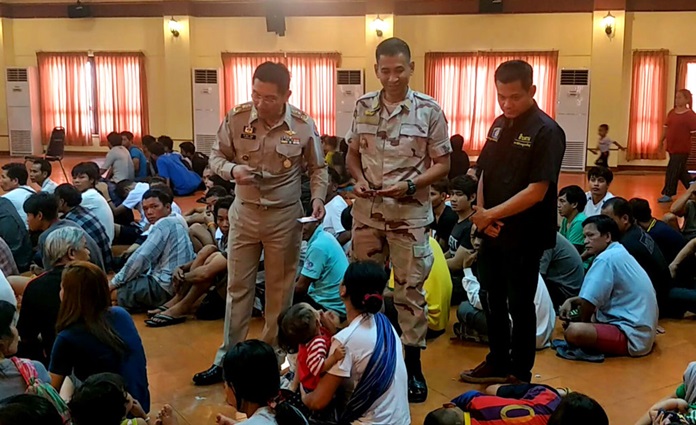 In this Aug. 28, 2018, photo, Thai officers talks to refugee and asylum seekers in Bangkok, Thailand. Thai police rounded up more than 160 refugees and asylum seekers from ethnic minorities in Vietnam and Cambodia who are believed to be at risk of persecution if they are returned to their homelands. (AP Photo