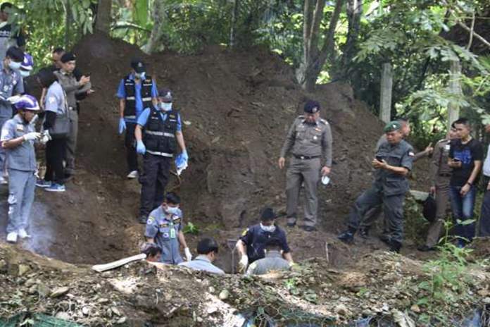 Thai officers stand by the area where the bodies of a murdered Briton and his Thai wife were found, in Phrae province, Thailand, Tuesday, Sept. 25. (Daily News via AP)