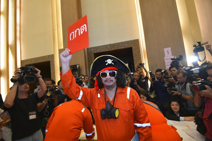 Pro-democracy political party leader Sombat Boonngamanong dresses as a pirate and holds a card in protest reading "Election Commission" in Bangkok, Friday, Sept. 28. (AP Photo)
