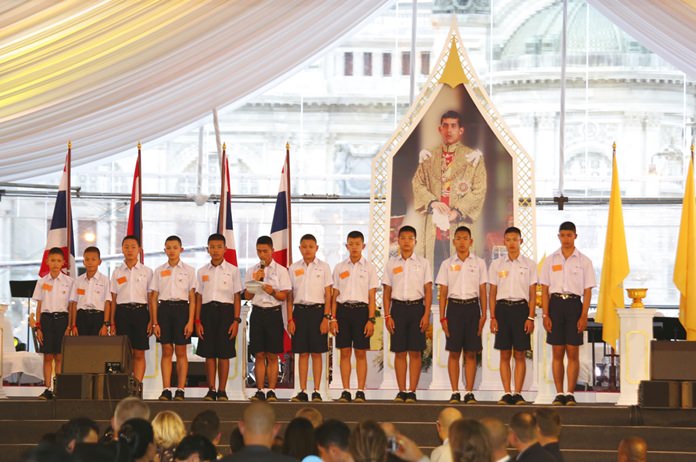 Members of the Wild Boars soccer team give their thanks during and event in front of the image of His Majesty King Maha Vajiralongkorn Bodindradebayavarangkun during the event titled "United as One" Bangkok, Thailand, Thursday, Sept. 6, 2018. Lalit)